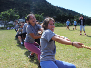 Seniors Lauren Remular and Alexandra Seto defend the honor of the Senior Class in the traditional tug-of-war contest against underclassmen. Students could choose from tug-of-war, kickball and water balloon competitions among other activities at Palolo park during the LIFE walk. 