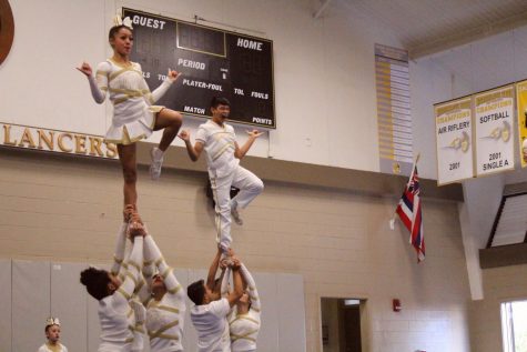 Male cheer team hoists over stereotypes