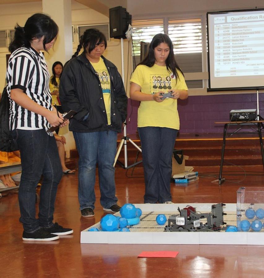 Eighth graders, Mindy Thai and Paige Mattos, competed in the first round of the VEX IQ competition at Pearl City High School for the middle school.