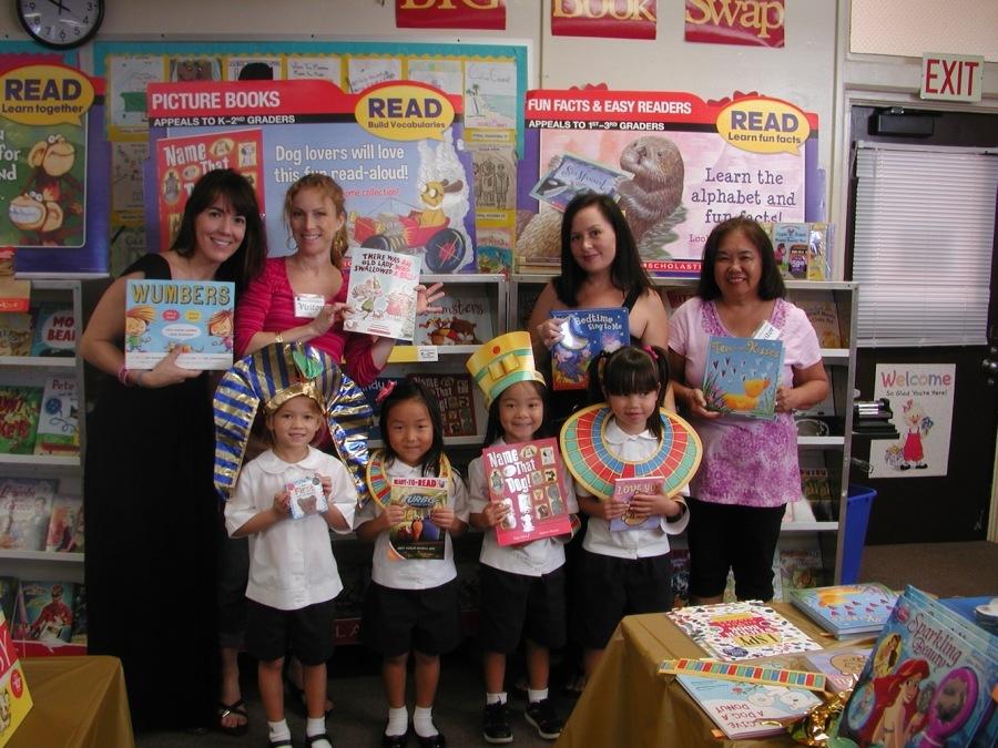 Lower school parents help at the Scholastic Book fair which encourages reading and raises funds for the library.