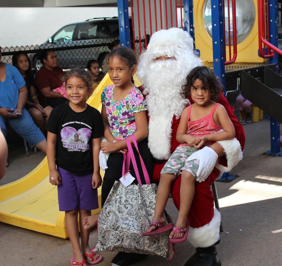 Santa Claus, senior Aiona Kava, distributed gifts from Academy families to residents of Loliana Hale, a transitional shelter in Kakaako. 