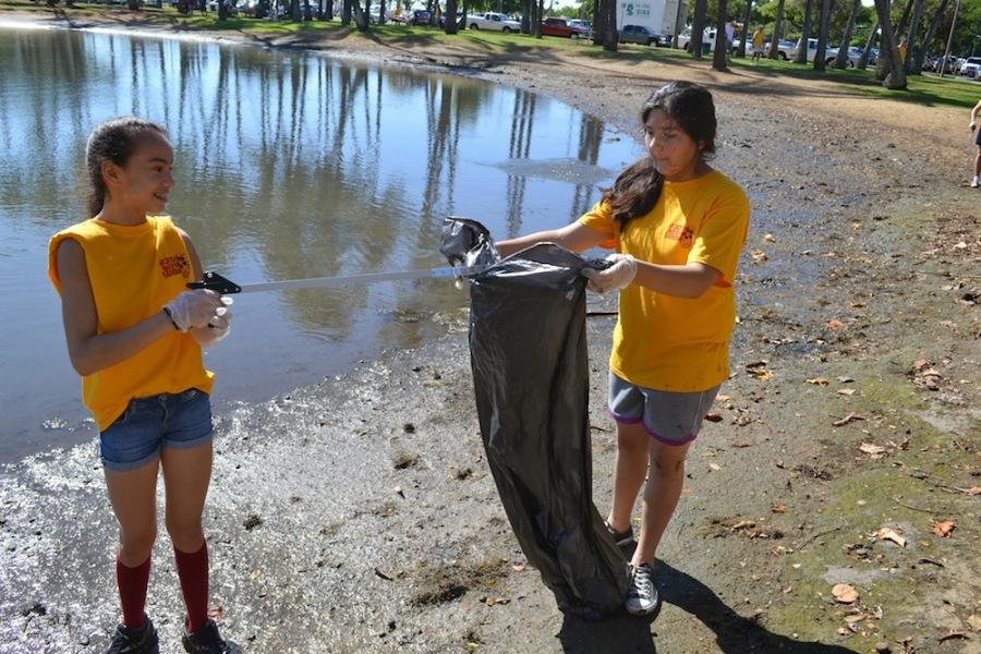 Lauren Pau-De Santos and Shelby Mattos worked to clean Ala Moana Beach Park with McKinley High Schools Leo club on Oct. 19.