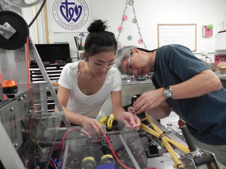 Senior Lynse Chock and her father Brian, an electrical engineer, work on the FIRST robot for this years competition, Aerial Assist.