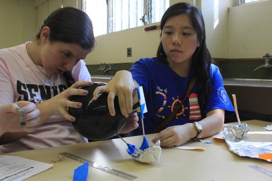 Senior Mara Gillis and junior Celina Ma compete in the boat building portion of the Physics Olympics at the University of Hawaii.