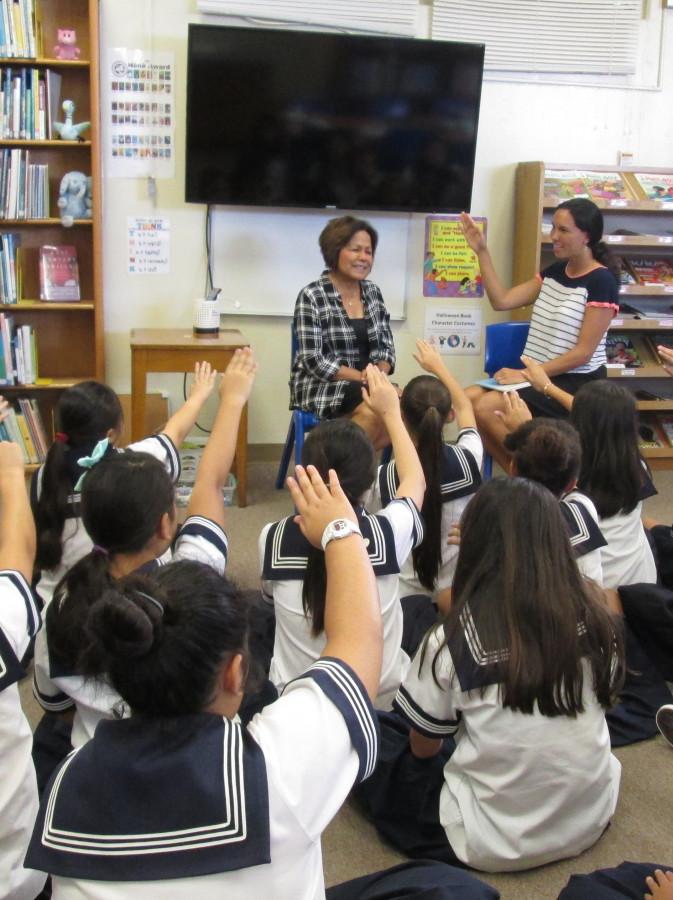 Remee Tam, lower school vice-principal, shares her birthday book with a sixth grade class. The book, I Wish You More by Amy Krouse Rosenthal and Tom Lichtenheld, is about endless good wishes - wishes for wonder, friendship, curiosity, strength, laughter and peace. The book provides encouragement and appreciation for the wonders of everyday moments. After the reading, students began creating their own stories on iPads. Photo credit: Laurel Oshiro