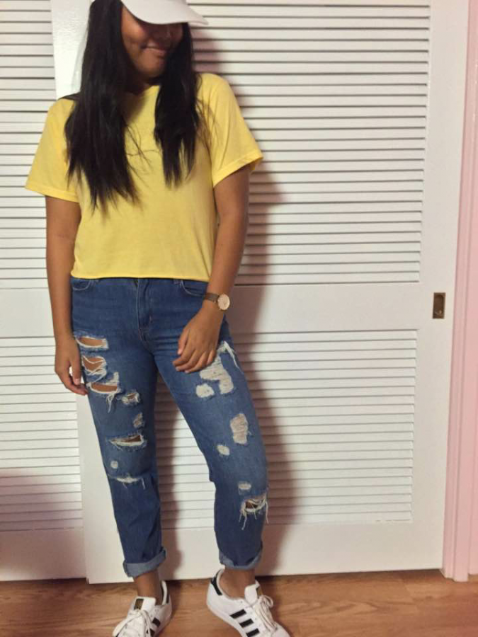 Academy sophomore Ragelle Lumapas is wearing a Brandy Melville crop top paired with Forever 21 “mom jeans” and white Adidas Superstar sneakers. This is one outfit combination popular this fall. Photo courtesy of Realesse Lumapas.