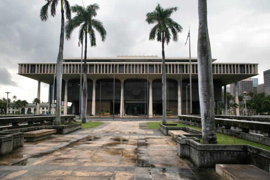 The Hawaii State Capitol, located in Downtown Honolulu, is also the burial site of hundreds who died in a 1980s measles outbreak. Photo Courtesy Wikimedia.