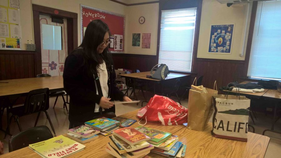 Sophomore division member Rin Inuzuka organizes 400 books donated by the sophomore class, as part of their service project.