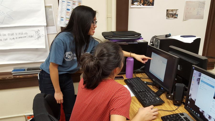 Tumacder helping senior Sydney Chock prepare for an upcoming cybersecurity competition.