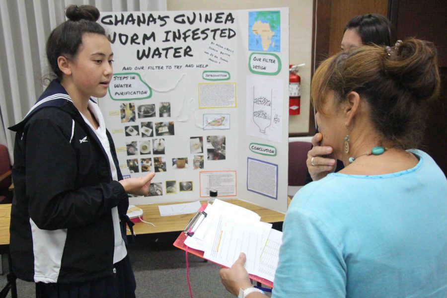 Melina O’Reilly  shares with teacher Mary Ellen Miller how she plans to purify guinea worm infested waters in Ghana.