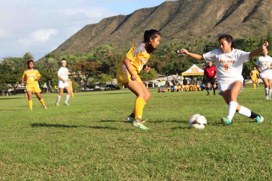 Sacred Hearts Academy sophomore Christiann Arakawa defends the ball against Pac-Five High School senior Kayla Kunihisa. The Lancers said Pac-Five was one of the toughest teams they played. Photo by Malie Woods.
