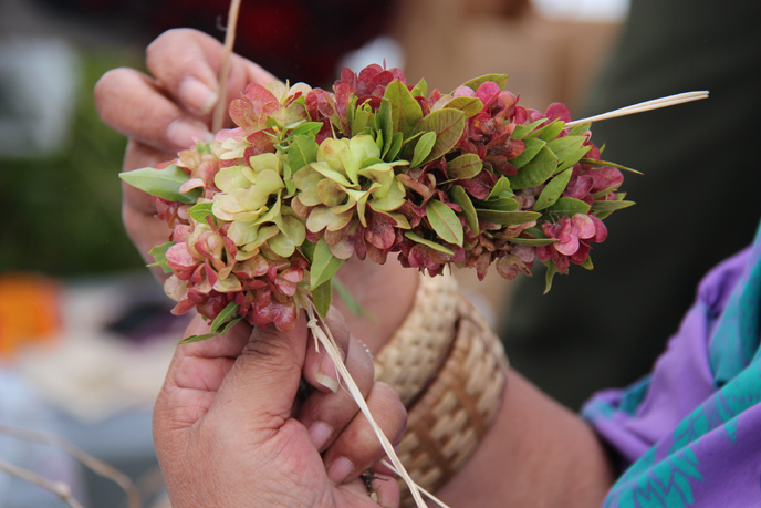 Making haku lei involves braiding floral pieces with twine. Photo courtesy of NPS.
