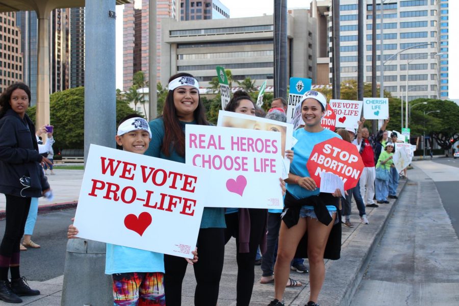 Advocates for pro-life waving signs at the Hawaii State Capitol. Photo by Grace Kim. 
