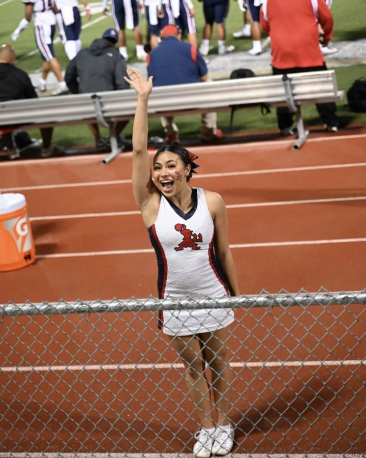 Academy senior Andromeda Tong cheers at her last football game earlier this school year. She’s excited for the offseason to get a much needed break off the mat. Photo courtesy of Robert Tong.

