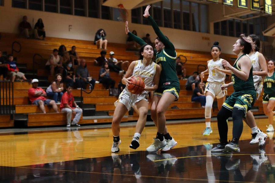 Varsity basketball player Kalysa Marie Ng prepares to take a shot during a game against Leilehua High School. Photo by Samantha Europa.