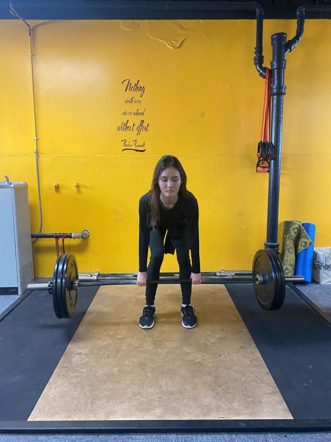 Sophomore Angelina Lind works out in the Academy’s weight room after school. She is preparing for the upcoming track and field season. Photo courtesy of Keira Mendonca.
 