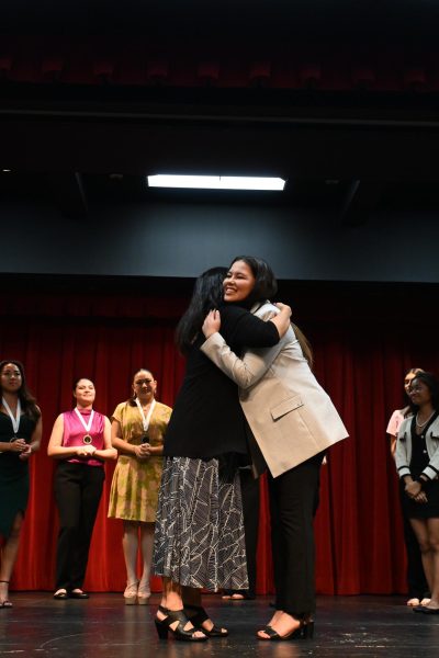 Scholastic judge Sara Satro
congratulates senior Madison Iwashita (right) on winning the Distinguished Young Women’s Award. Iwashita is the first Academy student to win this award since 1994. Photo courtesy of Kelsey Morihara.