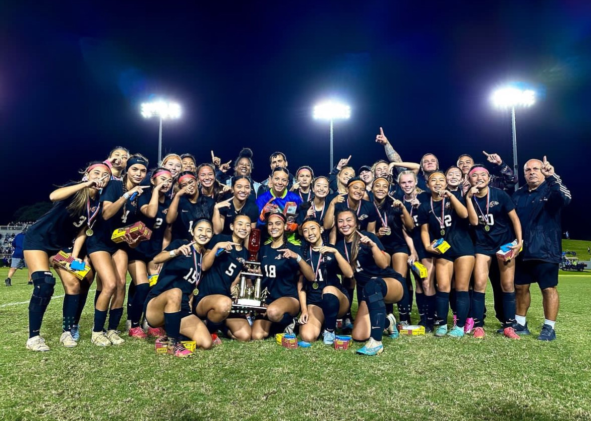 PAC-5 varsity Division II soccer team smiling through the blood, sweat and tears of their hard work. They boast a trophy as state champions for the third year in a row. Photo courtesy of Dowda-Gates.