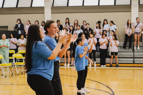The day begins in the campus gym, where pairs of LIFE Team members (photo left) Jetaime-Tihani Tajiri and Reagan Beissel and (photo right) Jayna Amasol and Keira Iwamoto lead the school in the gospel song, “Gloryland.” The liturgy brings together the Lower and Upper School students for Catholic Schools Week. The LIFE Team, or worship team, has a reputation of lighting up every mass or religious event with much enthusiasm for God. LIFE Day is at the forefront of these events, as the student members plan the day’s activities.