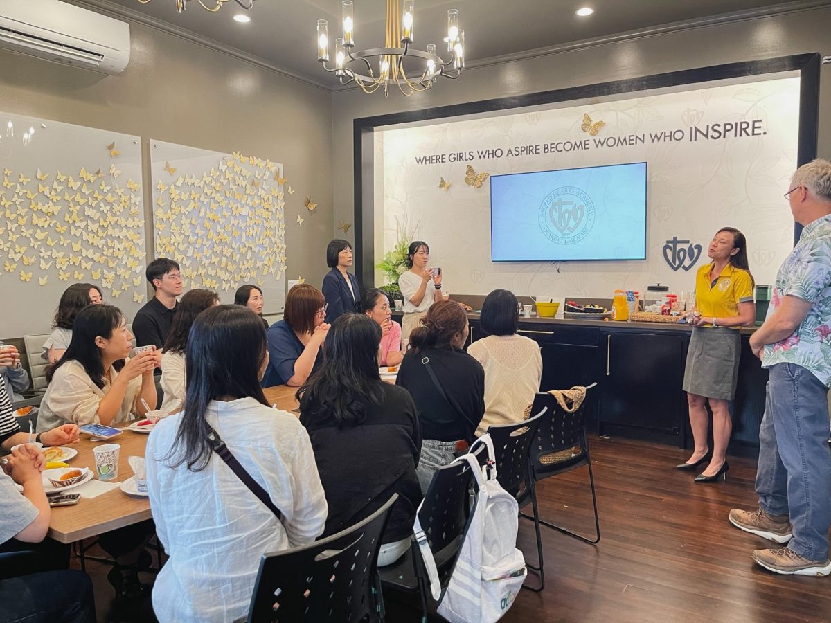 President Brandy Ann Sato presents in the campus Board Room, as the visiting teachers enjoy refreshments. They will take what they learned back to their classrooms in Korea. Photo courtesy of Cleo Eubanks.