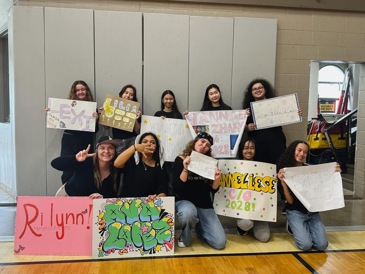 Top row: Freshmen Lexi Yeager, Lilia Gushiken, Evelyn Evie Arakaki, ZeHan Zhang, Olivia Eftink
Bottom row: Freshmen Rilynn Milczarski, Ava Lopez, Chloe Diaz, Anneliese Vanadilok, Izzabelle Chang holding posters that their big sisters made for them after performing. Photo by Liana Seo.
