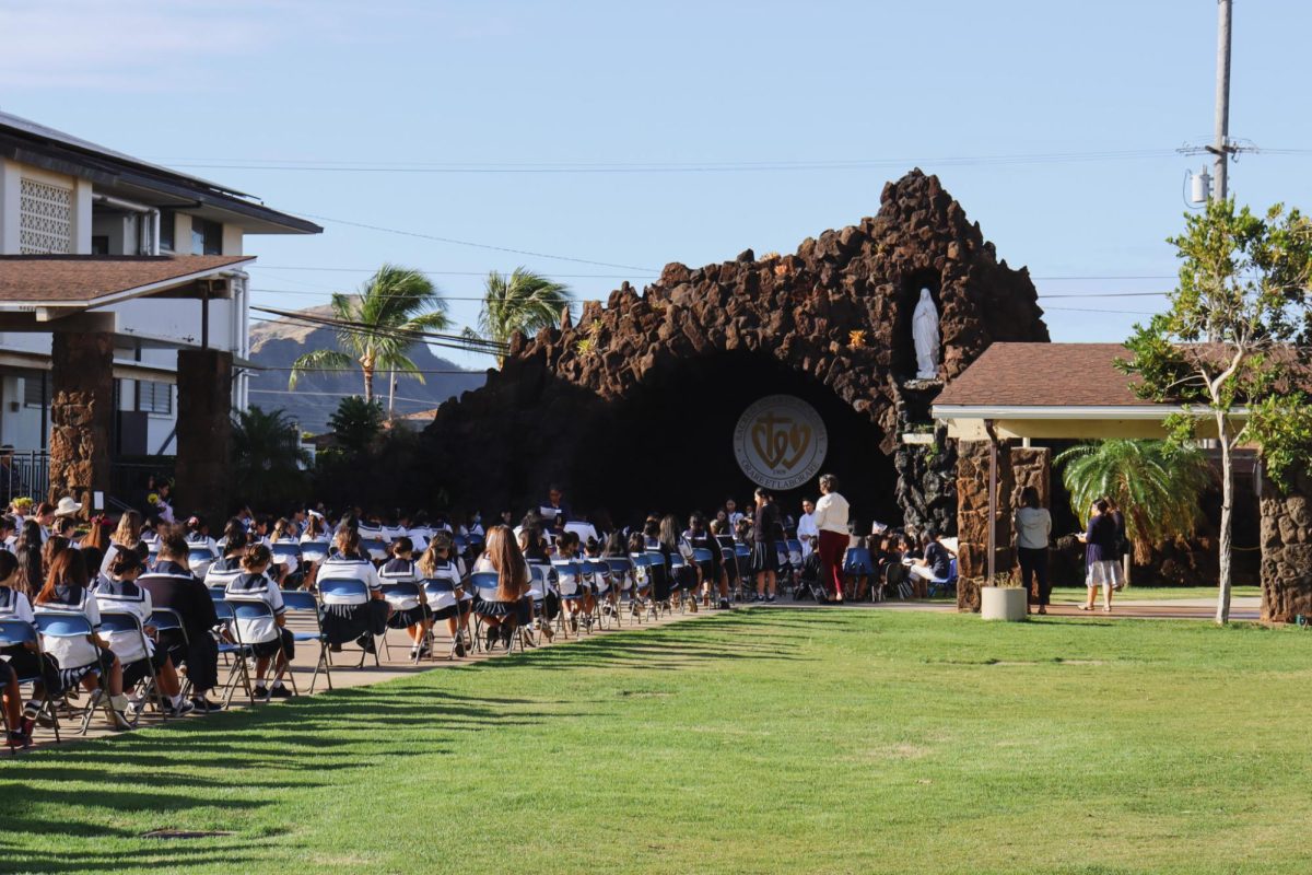 Sacred Hearts Academy hosted its first ever living rosary last month. In front of the grotto, readers prepare for their moment to read their prayer. Photo By Karys Shimizu.