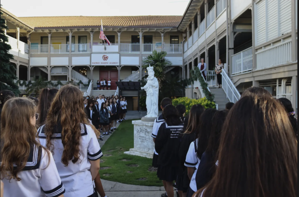 Sacred Hearts Academy students facing the Our Lady of Peace statue at flag. Photo by Asa Ardayfio