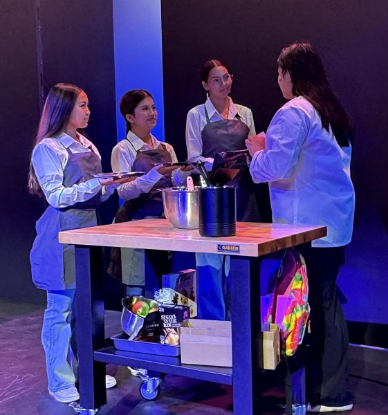 Sacred Hearts Academy seniors Alyssa Giang, Anna Casupang, Samaya Hogue, and Academy junior Sage Nguyen are on the stage of “Freaky Friday.” Giang, Casupang, and Hogue are seen as cater waiters, while Nguyen is a Torrey (assistant). 
