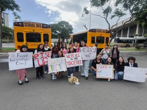 Mililani High School students hold handmade signs in support of Learning Centers. The students featured in the photo are participants in a performing arts program funded by Learning Centers. Due to the proposed budget, their program was at risk. Photo courtesy of Teah Vaoifi.
