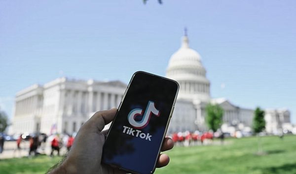 A phone displaying the app TikTok in front of the United States Capitol. The parent company of the popular video sharing platform, ByteDance, temporarily shutdown the app before resuming operations yesterday. Photo courtesy of the Cato Institute.