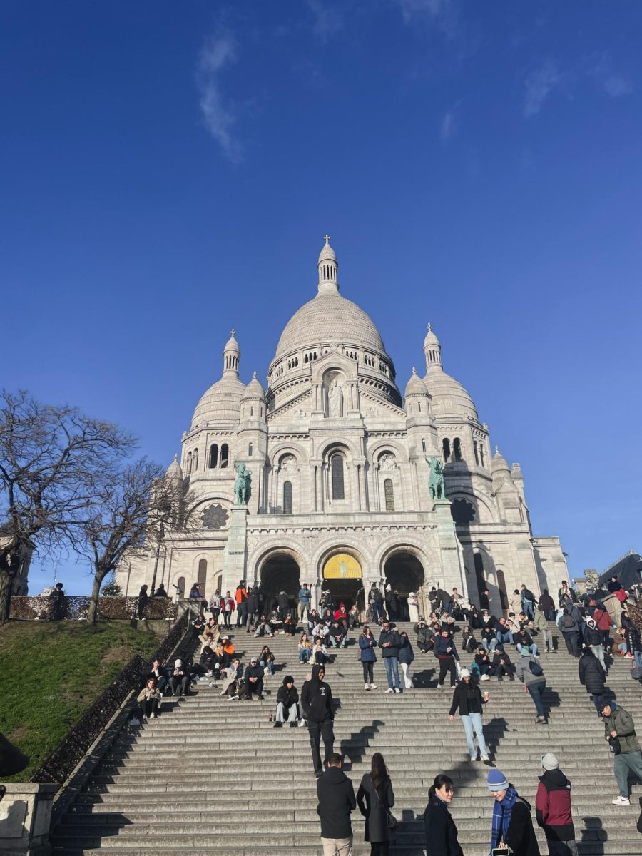 This is the main entrance of the church where many people gather each day to view this historic site. A statue representing the Sacred Heart of Christ sits at the top of the structure with other religious and French statues placed around the rest of the exterior. The two horse stautes above the arches depicts two French Saints, Joan of Arc and Saint Louis IX.