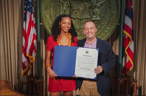 Sacred Hearts Academy senior Peyton Bennett stands with Governor Josh Green, holding the official Black History Month proclamation. After four years of advocacy and community work, Bennett successfully secured statewide recognition for Black History Month in Hawaii. Photo courtesy of Bennett,