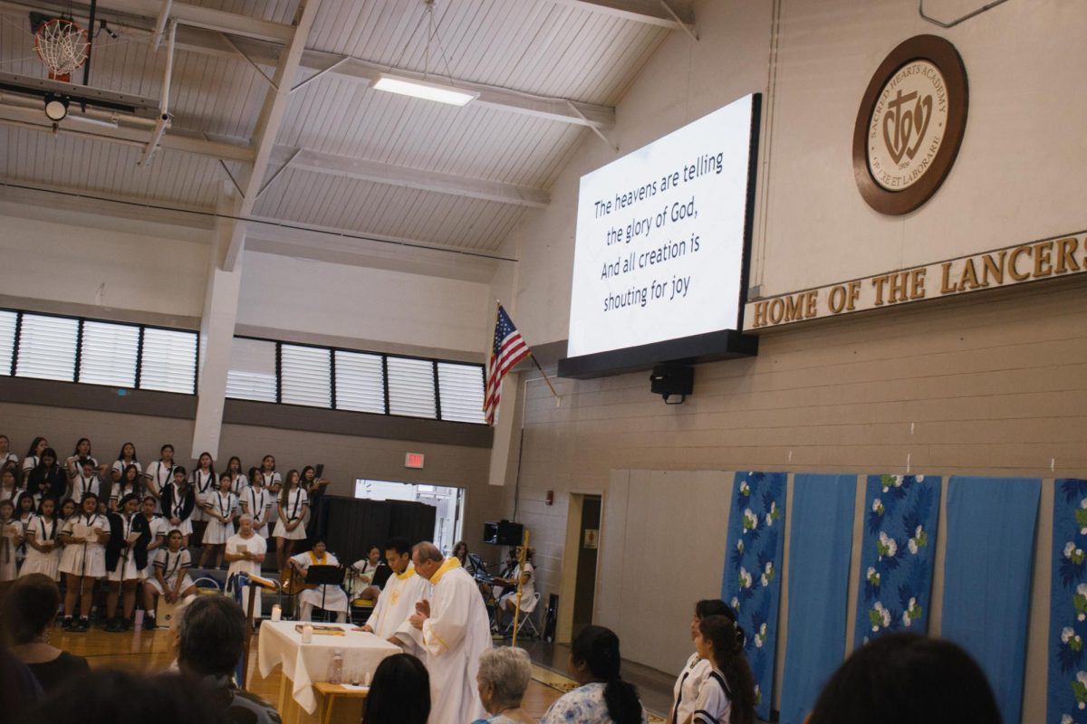 Sacred Hearts Academy holds its first Friday mass led by Fr. Jeremy, accompanied by Deacon Mike Browning. The school motto is engraved at the front of the gym, reminding Lancer students that we are the future of this generation and school.