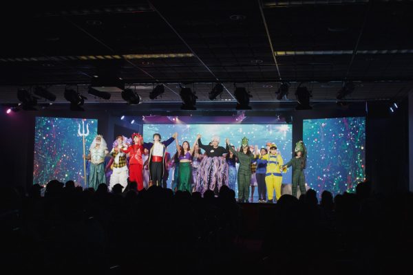 The “Little Mermaid Jr.” cast raises their hands triumphantly to bow, concluding their final play of the busy week. The student cast is made up of Academy students, along with students from local high schools and middle schools.

