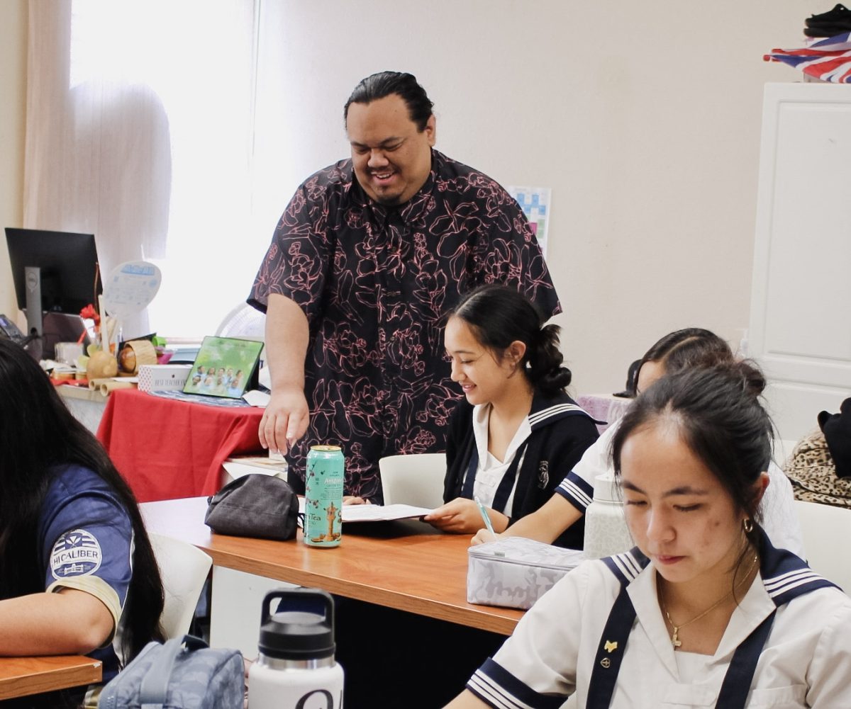 Kumu Jordan Kahaku Asing helps his students prepare for an upcoming presentation to celebrate Queen Liliʻuokalani’s birthday. Asing also teaches both the Hawaiian Language classes and the hula classes.