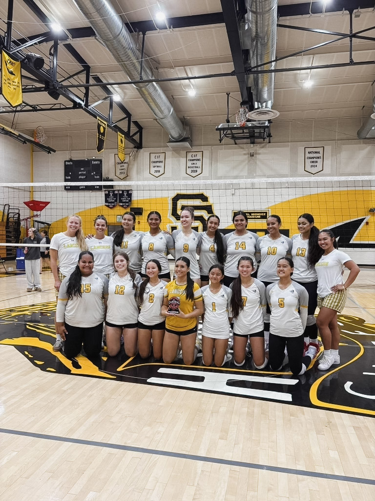  The varsity volleyball team prepares for the final day of their tournament, where they went on to win the silver bracket championship through hard work and dedication. 