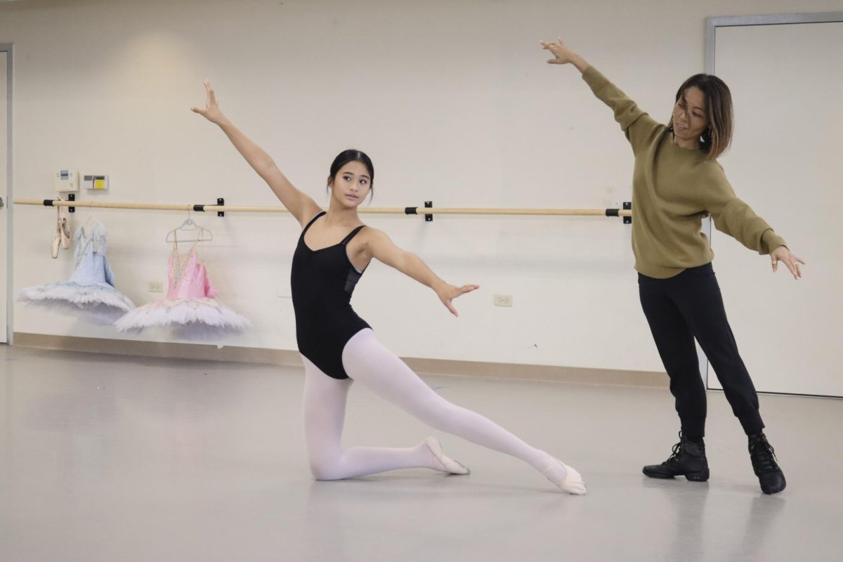 Duong assists eighth grader Liliko’i Baltunado to refine her hand placements. The ballet class was reviewing for the upcoming Nutcracker performance.