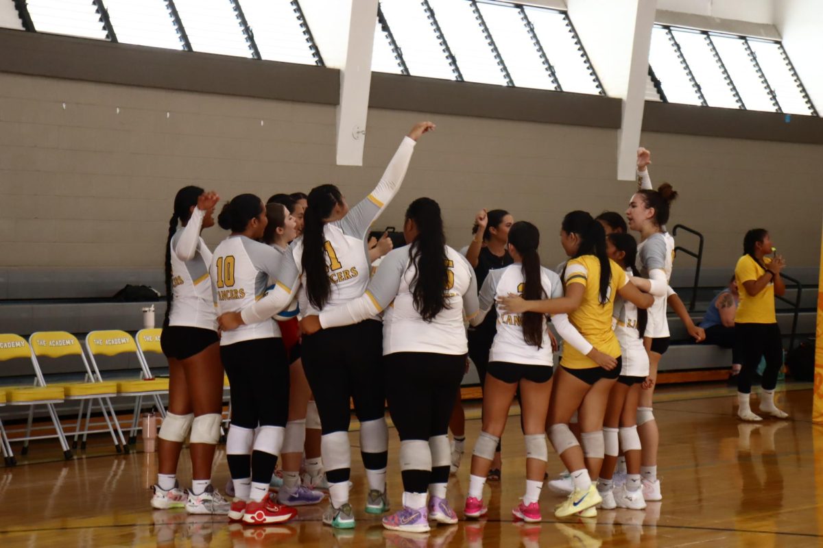 The Lancer volleyball team gathers in a huddle to pray before their first game, kicking off the tournament!
