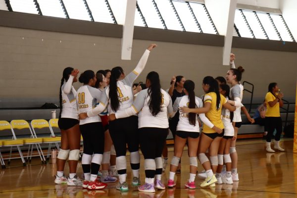 The Lancer volleyball team gathers in a huddle to pray before their first game, kicking off the tournament!
