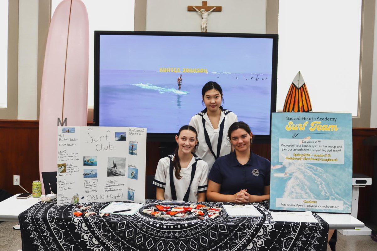 Surf team members sophomores Claire Pinkerton, Hannah Zhang and senior Sara Kea welcomed students to sign up for the club or team at this year’s club fair. Club members will assist the team this season by volunteering at competitions and earning service hours. Photo courtesy of Alyssa Myers.
