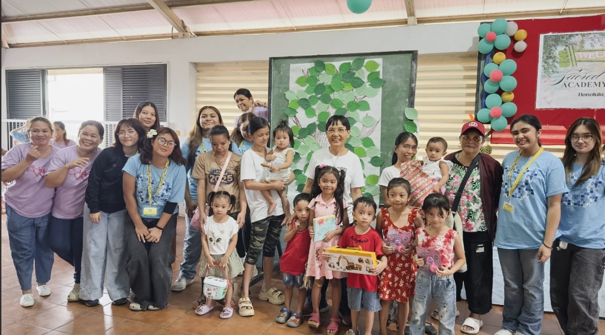 The Sacred Hearts Academy students take a group photo with community members in Bagong Silang during the Philippines mission trip. The students spent time taking and building friendships with the local community. Photo courtesy of Rochelle Narciso.