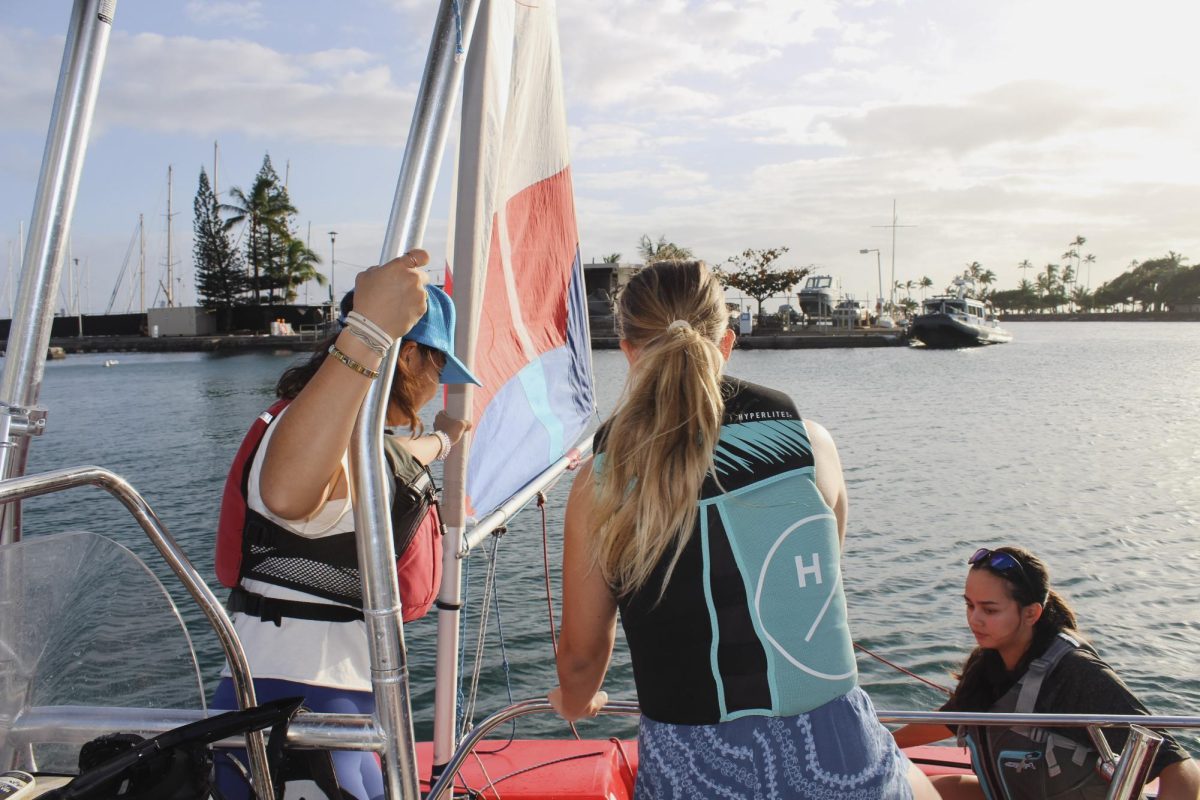 Under Coach Melody Fernandez’s guidance, students carefully trade places to keep the boat balanced and safe. Photo by Elora Speltz
