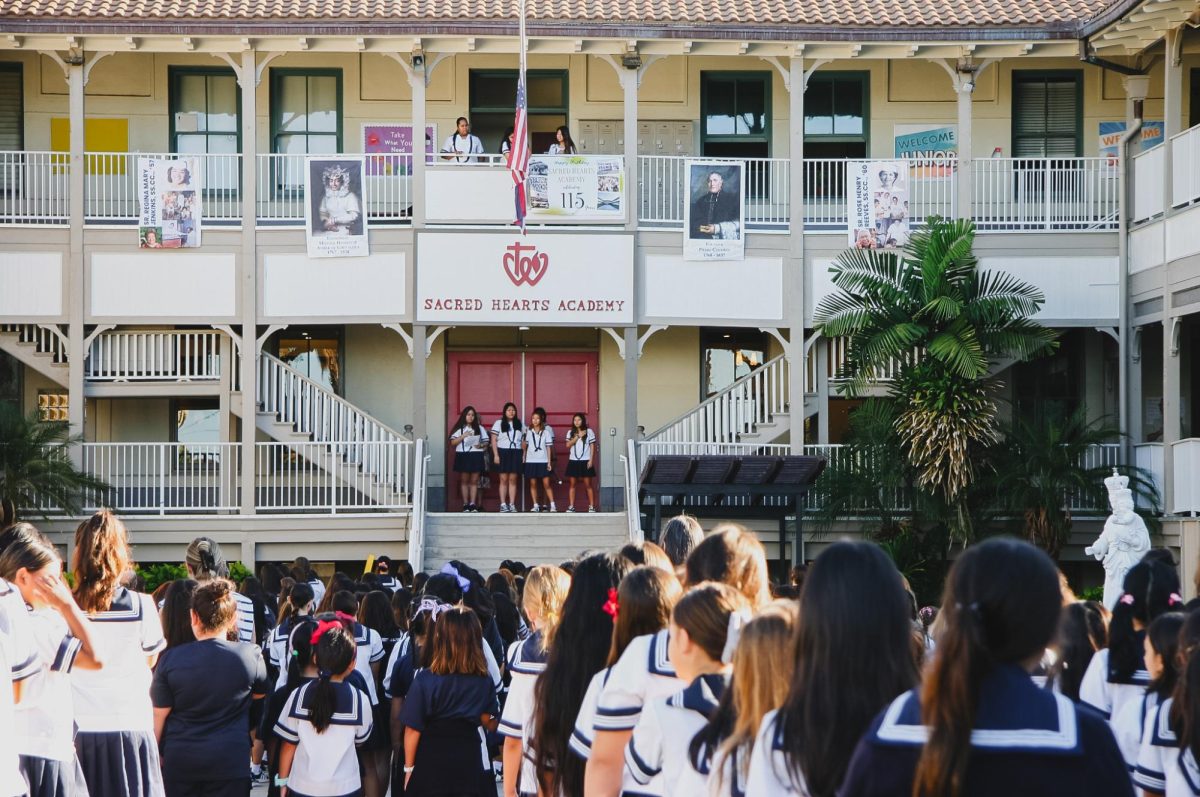 Academy students gather in the courtyard for a morning flag assembly. The area was once home to a large banyan tree that served as a central gathering place for students.