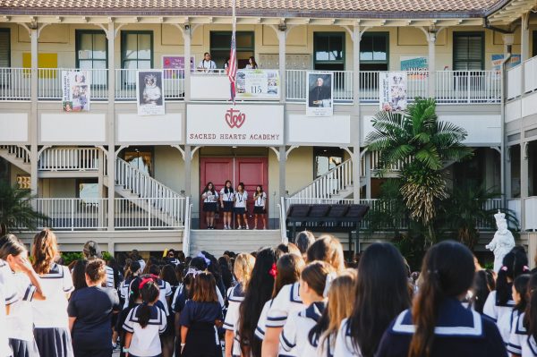 Academy students gather in the courtyard for a morning flag assembly. The area was once home to a large banyan tree that served as a central gathering place for students.