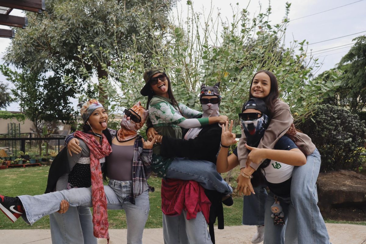 Six outfits, one shared theme. Sophomores Kalena Low, Kenna Souza, Bella Slagel, Maren Williams, Shelby-Cozy Bertram and Jojo Reyes dress up for Wacky Thursday during the sophomore division’s dress-down week at the Academy. Low, Souza, Williams and Bertram wear matching cat ski masks as part of their coordinated outfits.