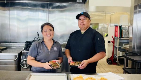 Aunty Michelle and Co-Woker holding one of the food items they prepared. They had just finished serving lunch to the upper school and are now prepping for clean up. Thank you for the food!