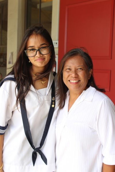Sinaia Joseph and Mrs. Asuncion proudly smiles with each other in front of the Academy’s front steps, representing the love of generations between them, supported by the many women who have walked these steps.